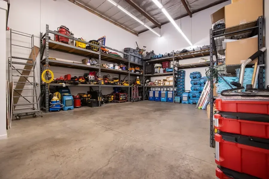 Air movers and dehumidifiers staged for a water damage dry-out