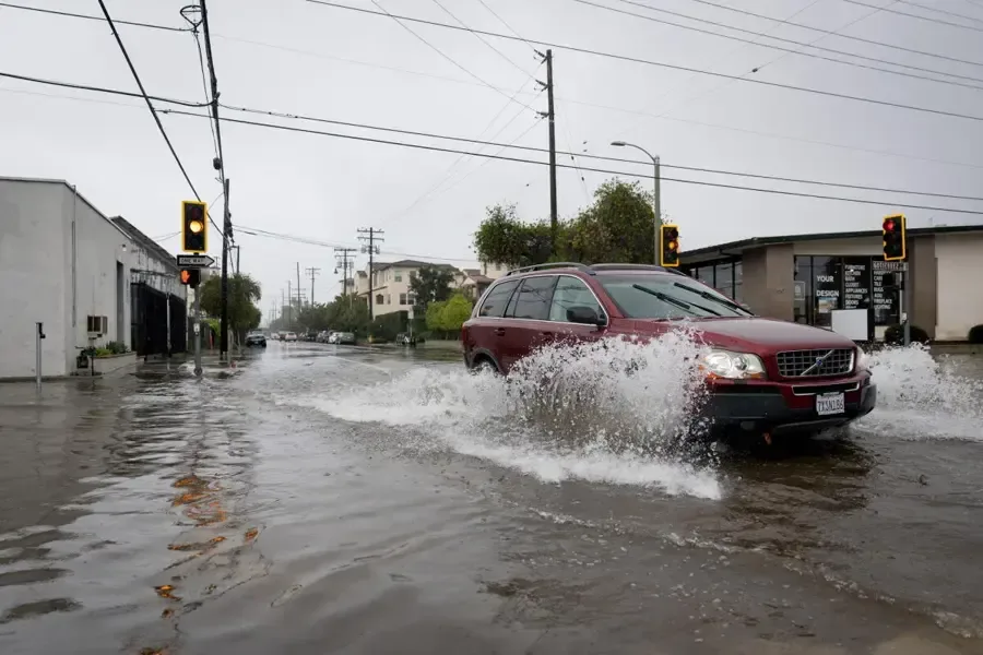 Storm water covering a residential street during a heavy downpour